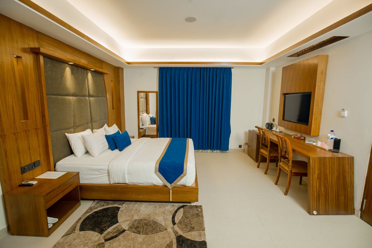 Mastering the First Impression: Your intriguing post title goes here Luxurious hotel room displaying modern interior design with elegant wooden furnishings.
