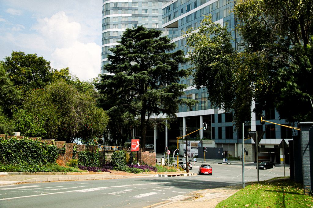 photo by ministar samuel A bustling street scene in Sandton, Gauteng, featuring modern skyscrapers and vibrant urban life.